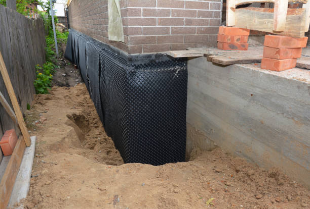 Happy homeowners after waterproofing job in Sand Lake